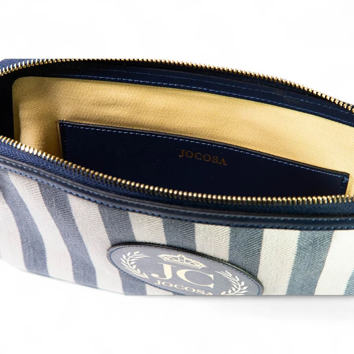 Close-up of the JOCOSA Locker Pouch interior, featuring beige lining, a navy leather pocket with embossed JOCOSA logo and gold-tone zipper.