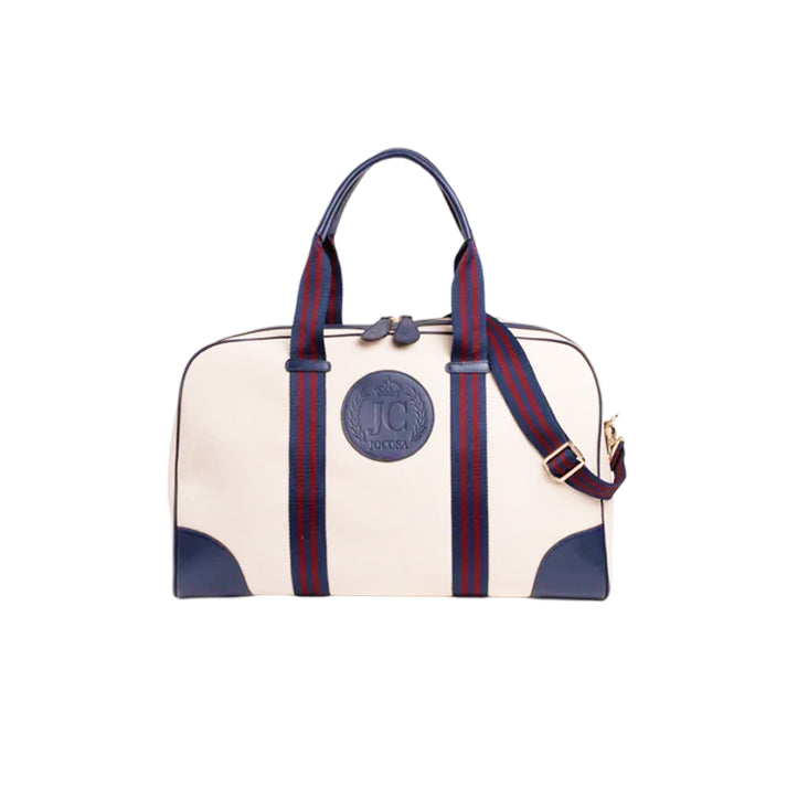 JOCOSA Club Carryall bag in ivory canvas with navy leather trim, navy and bordeaux striped handles, detachable shoulder strap and embossed leather logo.